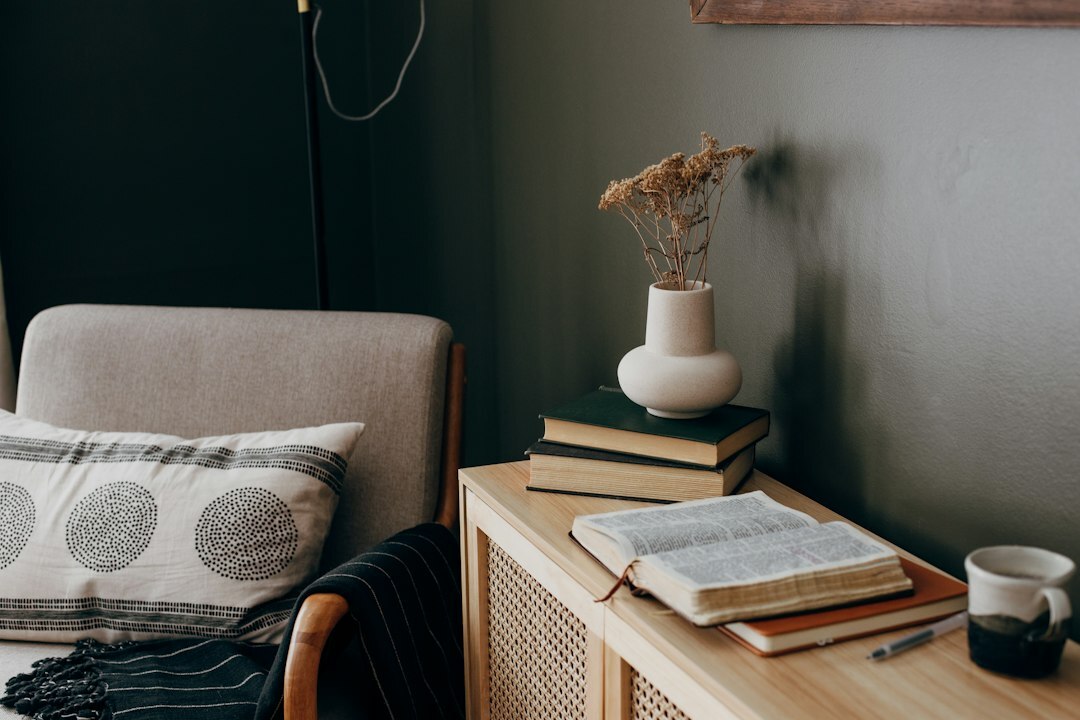 Cozy home study room with tall bookshelves and warm lamp light